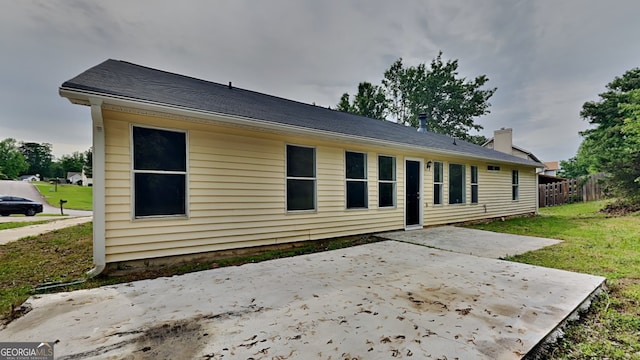 1229 Huntington Place Cir, Lithonia, GA 30058 - rear view of house with a yard, a patio, fence, and a chimney