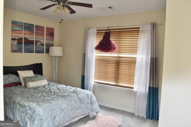 bedroom with carpet floors, baseboards, ceiling fan, and visible vents