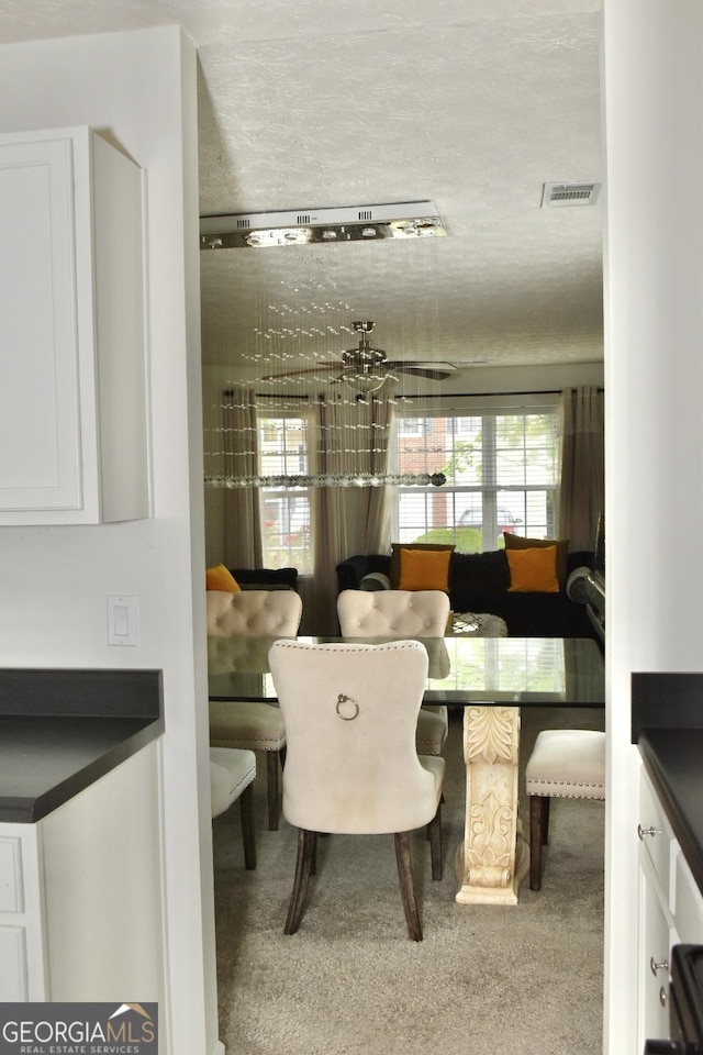 dining area with plenty of natural light, carpet, and visible vents