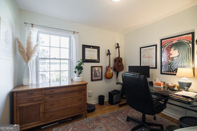 office space featuring baseboards and wood finished floors