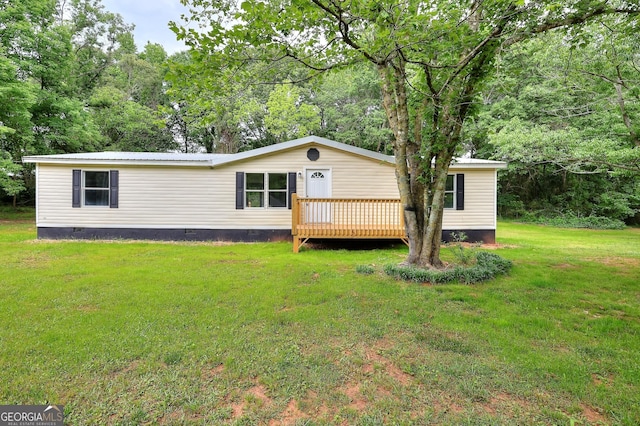 manufactured / mobile home featuring crawl space, metal roof, a front lawn, and a deck
