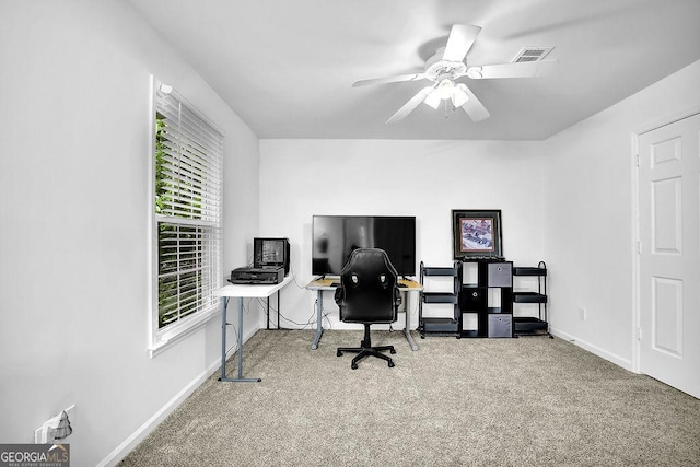 carpeted office with baseboards and ceiling fan