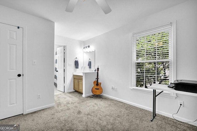 unfurnished bedroom featuring multiple windows, light colored carpet, and baseboards