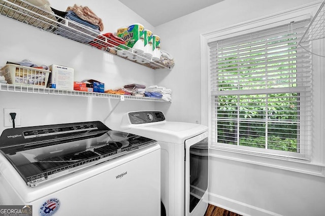 washroom with separate washer and dryer, healthy amount of natural light, and baseboards