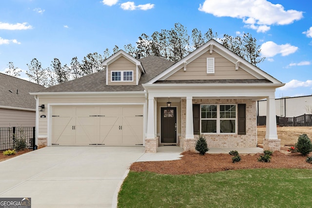 1216 Cedarcrest Blvd, Acworth, GA 30101 - craftsman-style house featuring covered porch, an attached garage, driveway, brick siding, and roof with shingles