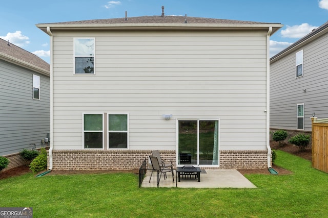 4777 Waxwing St, Hoschton, GA 30548 - rear view of property featuring a lawn, brick siding, fence, and a patio area