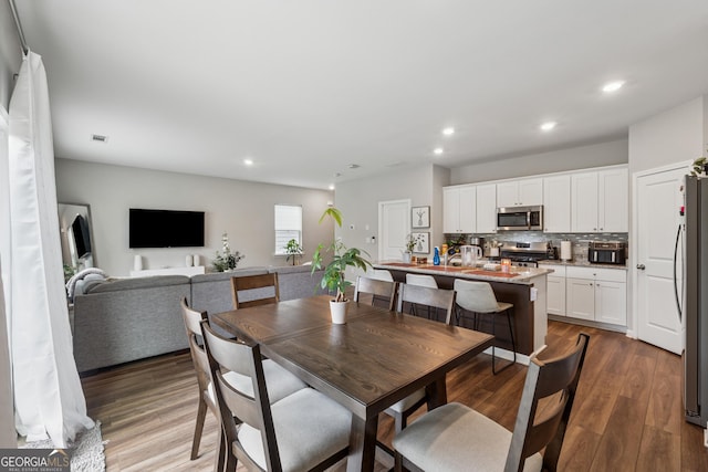 4777 Waxwing St, Hoschton, GA 30548 - dining space featuring recessed lighting, wood finished floors, and visible vents