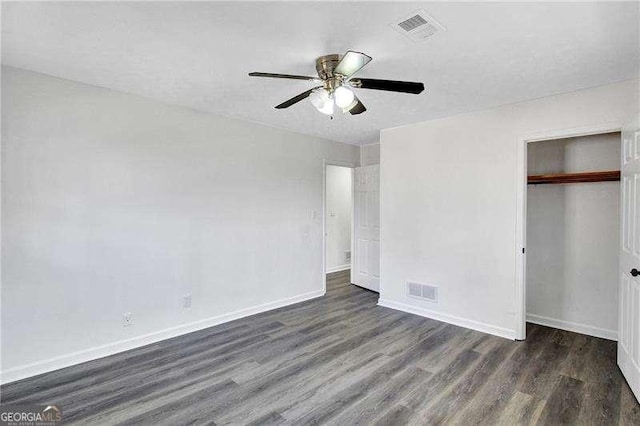 unfurnished bedroom with wood finished floors, a closet, baseboards, and a ceiling fan