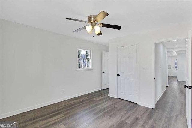 unfurnished bedroom with wood finished floors, attic access, baseboards, a ceiling fan, and recessed lighting