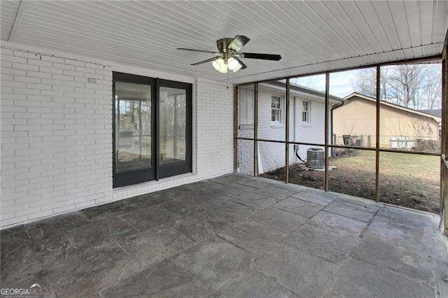 unfurnished sunroom with a ceiling fan