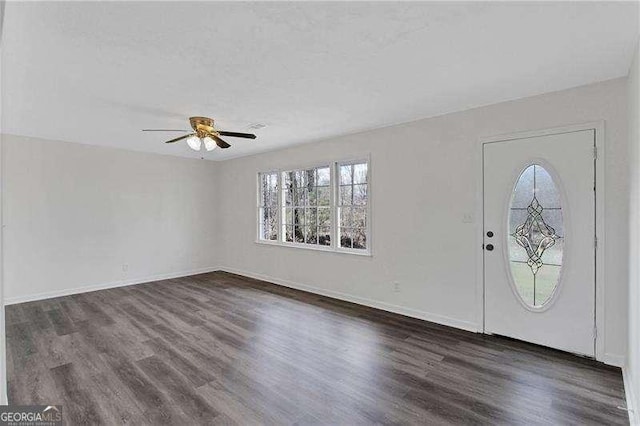 entrance foyer with healthy amount of natural light, dark wood finished floors, a ceiling fan, and baseboards