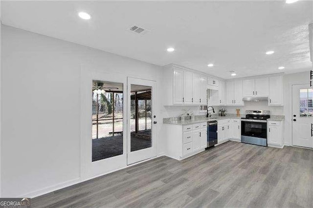 kitchen featuring stainless steel range with electric stovetop, dishwasher, light countertops, a sink, and recessed lighting