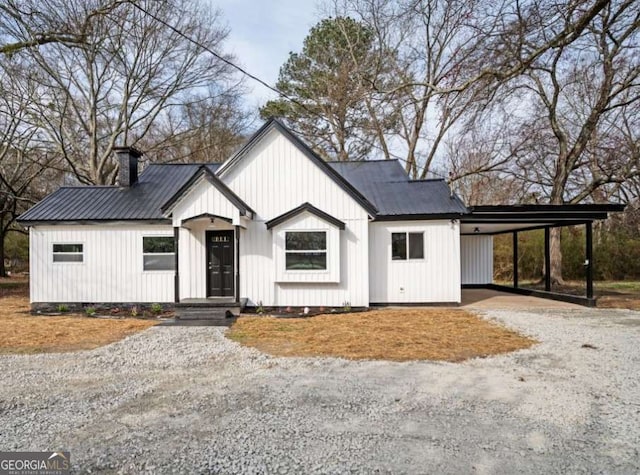 65 Sage St, Temple, GA 30179 - modern inspired farmhouse featuring an attached carport, driveway, a chimney, and metal roof