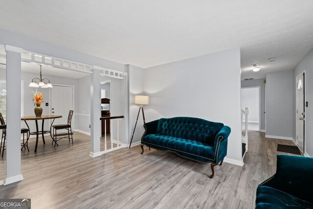 100 Fairview Dr, Stockbridge, GA 30281 - living area featuring an inviting chandelier, baseboards, wood finished floors, and visible vents