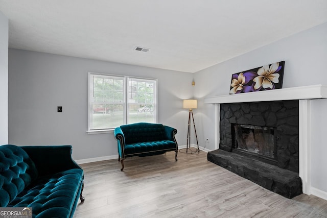 100 Fairview Dr, Stockbridge, GA 30281 - living area with baseboards, a fireplace, wood finished floors, and visible vents