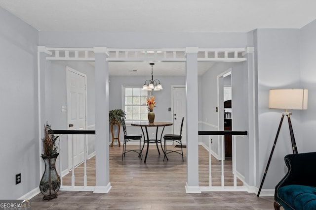 100 Fairview Dr, Stockbridge, GA 30281 - interior space with baseboards, a notable chandelier, and wood finished floors