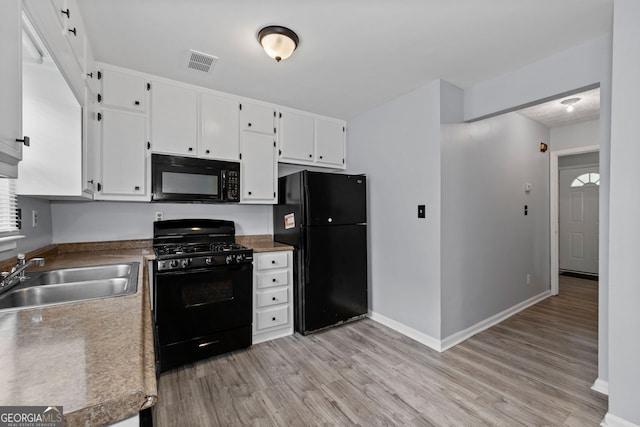100 Fairview Dr, Stockbridge, GA 30281 - kitchen featuring white cabinets, a sink, light wood-style floors, visible vents, and black appliances