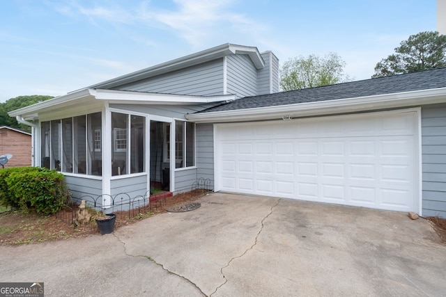 100 Fairview Dr, Stockbridge, GA 30281 - view of front of property featuring a sunroom, a garage, a shingled roof, and concrete driveway