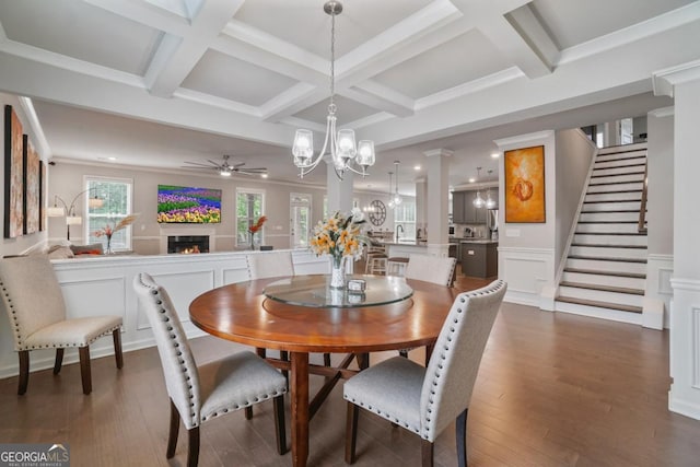 317 Basel Way, Hampton, GA 30228 - dining space with a chandelier, ceiling fan, a warm lit fireplace, coffered ceiling, and dark wood-type flooring