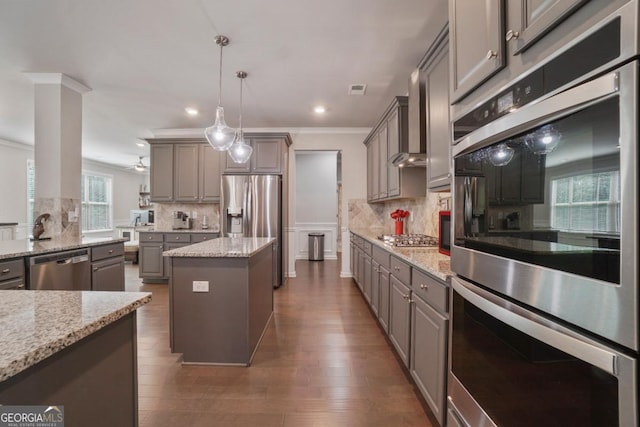 317 Basel Way, Hampton, GA 30228 - kitchen with gray cabinetry, stainless steel appliances, a kitchen island, tasteful backsplash, and ornamental molding