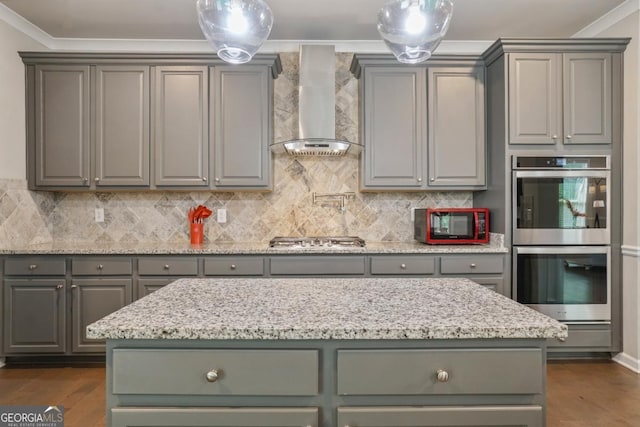 317 Basel Way, Hampton, GA 30228 - kitchen featuring wall chimney exhaust hood, stainless steel appliances, gray cabinetry, and ornamental molding