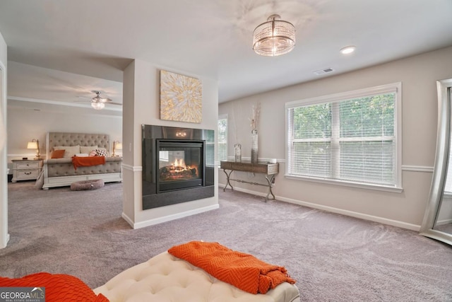 317 Basel Way, Hampton, GA 30228 - living room with carpet, a multi sided fireplace, and ceiling fan