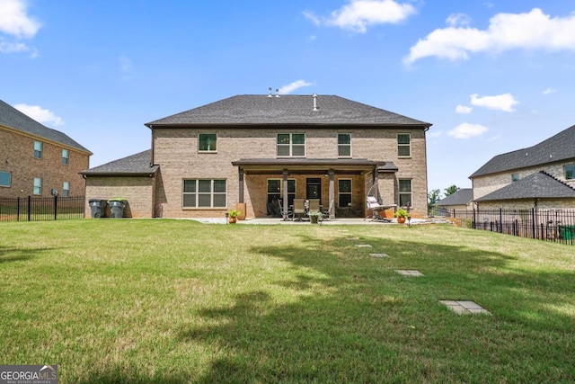 317 Basel Way, Hampton, GA 30228 - back of property featuring a patio, a fenced backyard, and brick siding