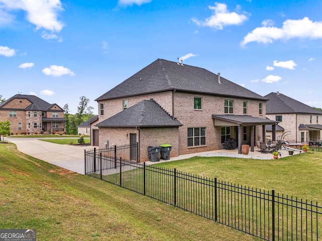 317 Basel Way, Hampton, GA 30228 - back of property with brick siding, concrete driveway, a patio area, a garage, and a shingled roof