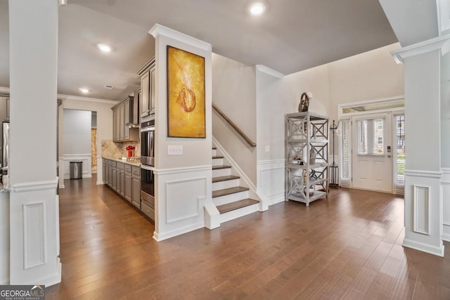 317 Basel Way, Hampton, GA 30228 - foyer entrance featuring a decorative wall, ornate columns, wainscoting, dark wood-type flooring, and recessed lighting