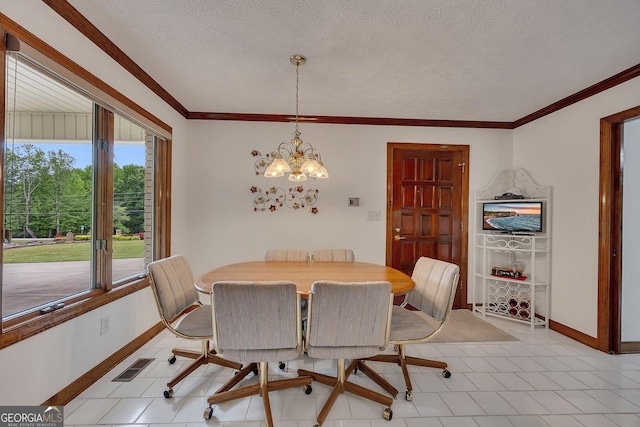 dining room with crown molding, a notable chandelier, a textured ceiling, baseboards, and visible vents