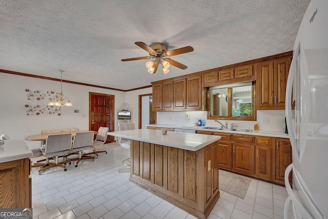 kitchen with brown cabinetry, freestanding refrigerator, and light countertops