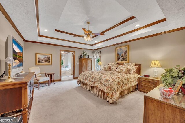 bedroom featuring crown molding, a tray ceiling, and light colored carpet