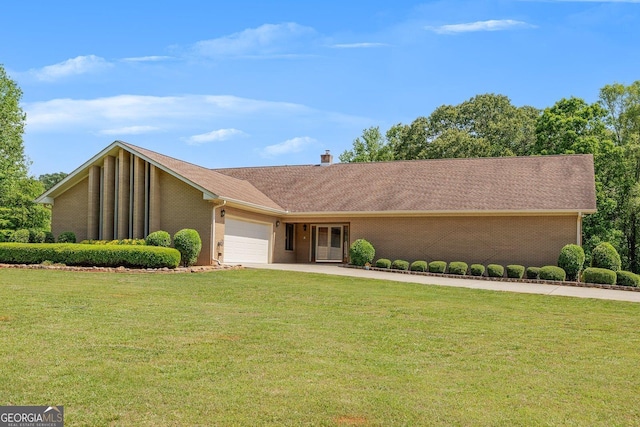 view of front of home featuring concrete driveway, brick siding, an attached garage, and a front yard