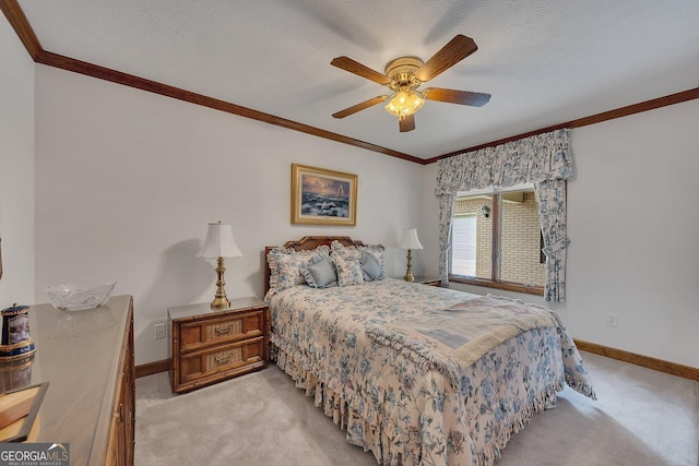 bedroom featuring carpet floors, a ceiling fan, baseboards, and crown molding