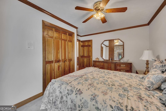 carpeted bedroom featuring baseboards, ornamental molding, a closet, and ceiling fan