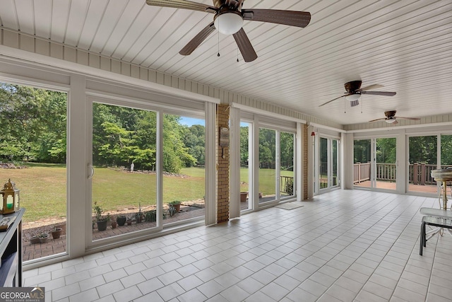 unfurnished sunroom featuring ceiling fan