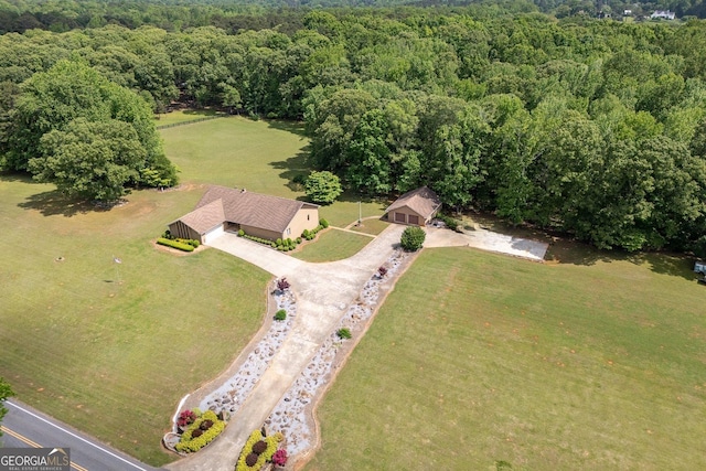 drone / aerial view featuring a wooded view