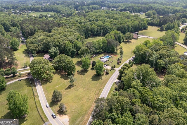bird's eye view featuring a wooded view