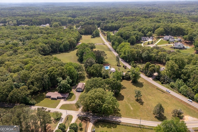 birds eye view of property with a view of trees