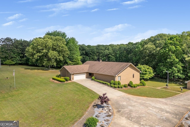view of front of house with an attached garage, stucco siding, driveway, and a front lawn
