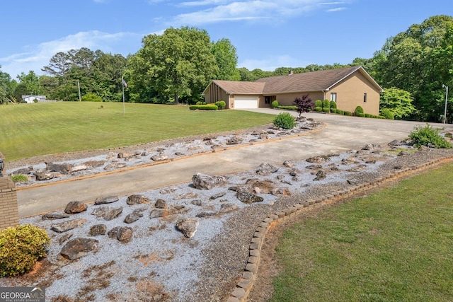 view of property exterior featuring a yard, an attached garage, and concrete driveway