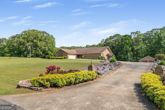 view of property exterior with a lawn and an outbuilding