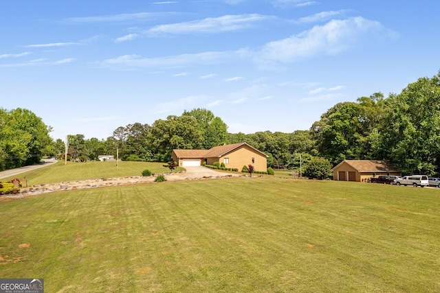 view of yard featuring a garage and driveway