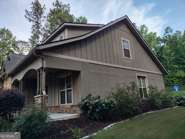 57 Deer Creek Run, Moreland, GA 30259 - view of property exterior featuring board and batten siding, stone siding, and a porch