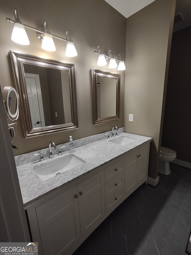57 Deer Creek Run, Moreland, GA 30259 - bathroom featuring baseboards, double vanity, toilet, and a sink