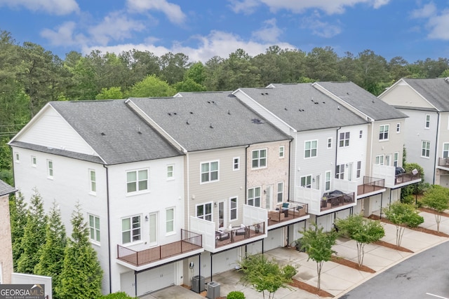 10200 Windalier Way, Roswell, GA 30076 - back of property featuring a shingled roof, an attached garage, and cooling unit