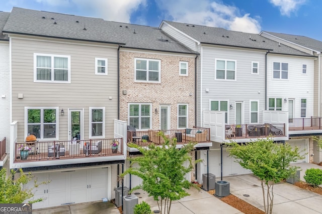 10200 Windalier Way, Roswell, GA 30076 - back of property featuring an attached garage, a balcony, and cooling unit