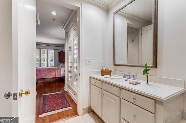 1717 N Decatur Rd NE Unit 214, Atlanta, GA 30307 - bathroom with vanity, ornamental molding, ensuite bath, and wood finished floors