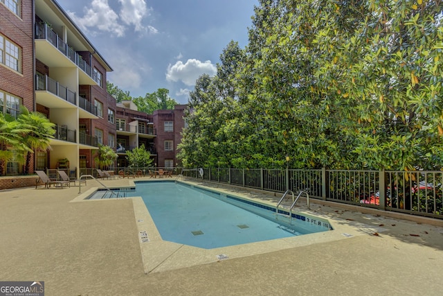 1717 N Decatur Rd NE Unit 214, Atlanta, GA 30307 - pool featuring a patio and fence