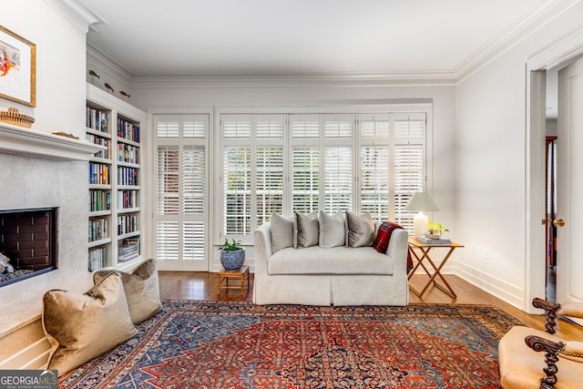 1717 N Decatur Rd NE Unit 214, Atlanta, GA 30307 - living area with crown molding, a premium fireplace, baseboards, and wood finished floors